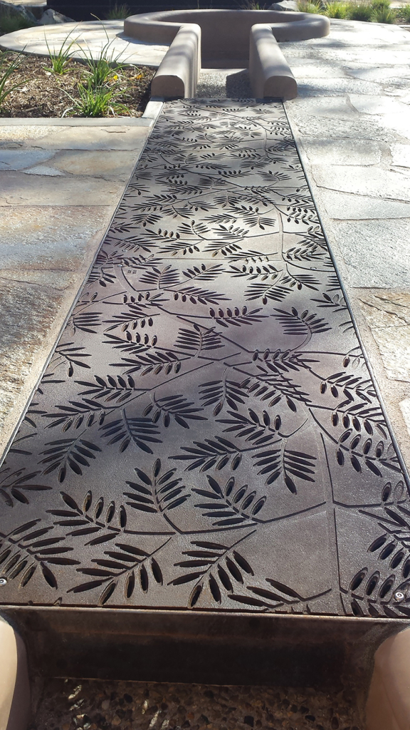 Cast iron grates in decorative Locust pattern by Iron Age Designs. Arrayed as a pedestrian bridge.