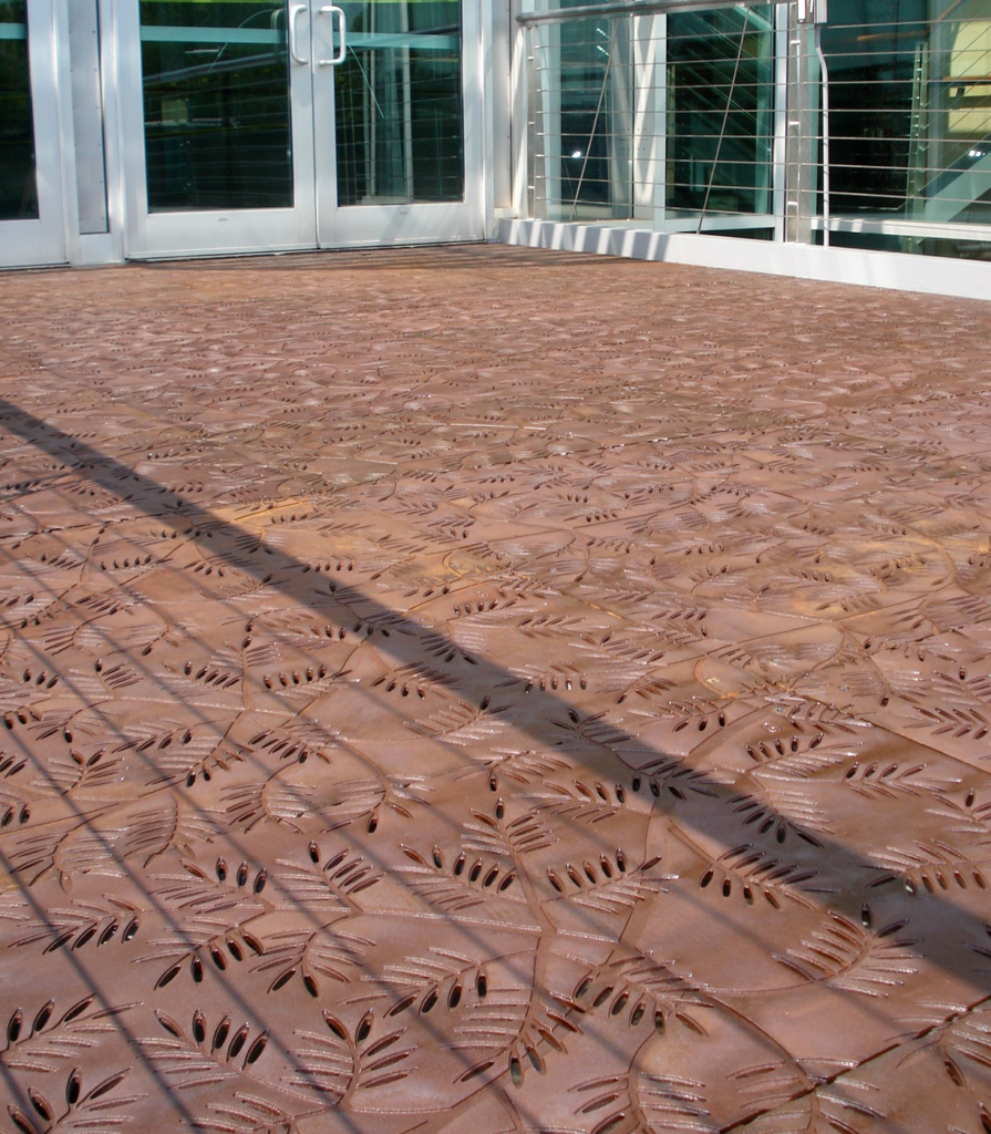 Cast iron grates in decorative Locust pattern by Iron Age Designs. Arrayed as a pedestrian bridge deck.