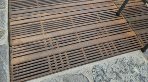 Cast iron grates in decorative Madras pattern by Iron Age Designs. Arrayed as a large tree grate.