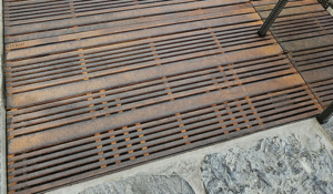 Cast iron grates in decorative Madras pattern by Iron Age Designs. Arrayed as a large tree grate.