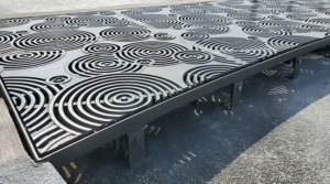 Cast iron grates in decorative Oblio pattern by Iron Age Designs. Arrayed as large stormwater inlet.