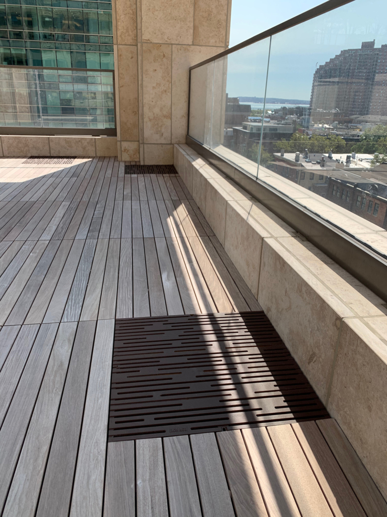Cast iron grate in decorative Rain pattern by Iron Age Designs. Baked-on-oil finish. Rooftop deck installation.