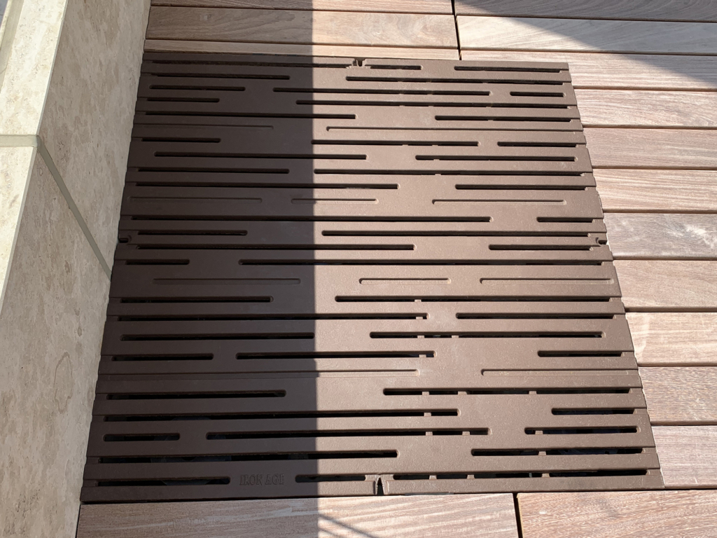 Cast iron grate in decorative Rain pattern by Iron Age Designs. Baked-on-oil finish. Rooftop deck installation.