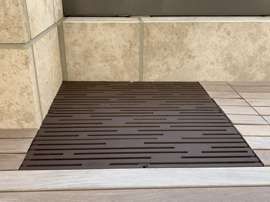 Cast iron grate in decorative Rain pattern by Iron Age Designs. Baked-on-oil finish. Rooftop deck installation.