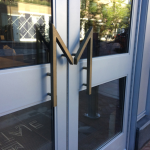 Cast bronze door pull in shape of M
