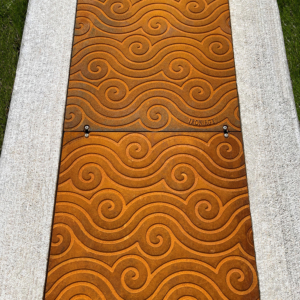 Bioswale drain channel with decorative, cast iron Argo solid covers.