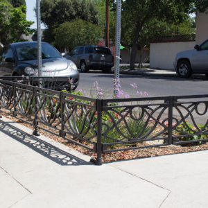 Decorative cast iron planter fence in Belle pattern with black powder coat finish.