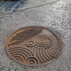 Cast iron custom plaque for Calabazas Creek with circular Oblio pattern