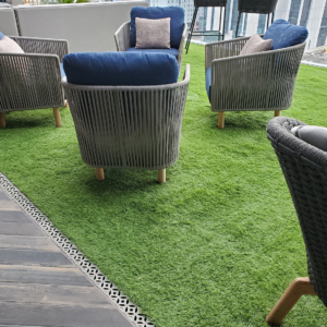 Decorative cast aluminum trench grate in classic Interlaken pattern on rooftop pool deck and restaurant