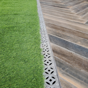 Decorative cast aluminum trench grate in classic Interlaken pattern on rooftop pool deck and restaurant