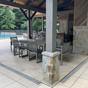 Decorative cast aluminum trench grates with Interlaken pattern installed in pool patio