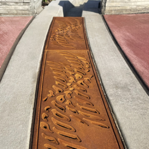 Cast iron radius trench grate with custom 'braid' pattern