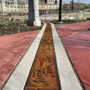 Cast iron radius trench grate with custom 'braid' pattern