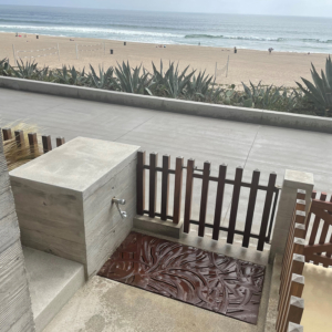 Decorative cast iron grate with Kelp pattern installed as floor of beach foot bath.