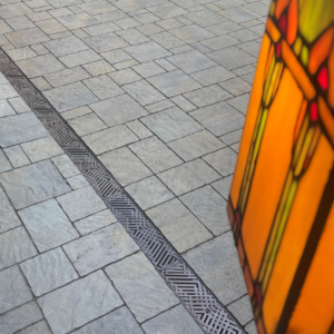 Decorative cast iron trench grates with southwest influenced Thunderbird pattern