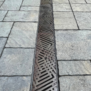 Decorative cast iron trench grates with southwest influenced Thunderbird pattern