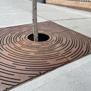 Decorative cast iron tree grate with concentric circular 'Spin' design