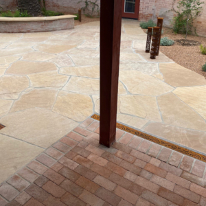 Decorative cast iron trench grate installed in paver patio