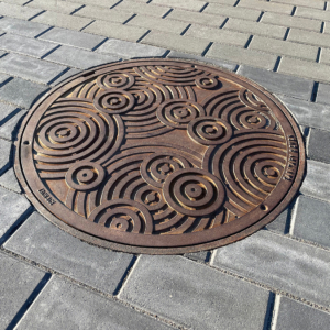 Decorative cast iron manhole cover in Oblio pattern