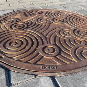 Decorative cast iron manhole cover in Oblio pattern