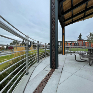 Decorative trench grates installed over pergola downspouts and in ground plane