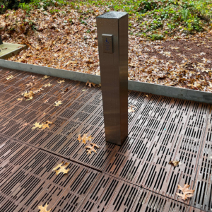 Decorative cast metal pedestrian bridge with ADA door button post