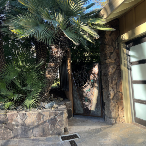 Decorative cast iron trench grates in River Rock pattern, installed in residential driveway