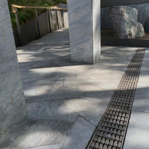 Decorative cast iron trench grate in Plex pattern installed in pavers