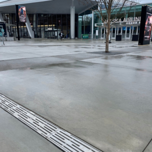 Cast aluminum decorative trench grate installed in entry plaza to Climate Pledge Arena