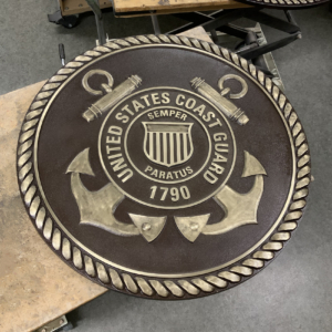 Cast Bronze plaque with "United States Coast Guard" around border and insignia in the middle