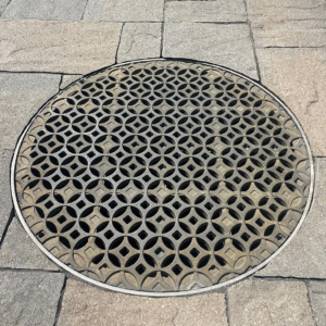 24" Dia. catch basin grate in cast bronze with decorative Interlaken pattern