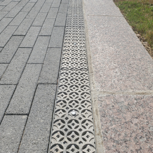 Cast aluminum trench drain grates in decorative Interlaken pattern