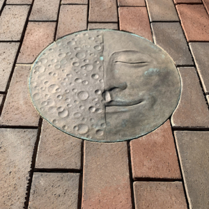 Cast bronze Moon Face embed plaque showing Half Moon face