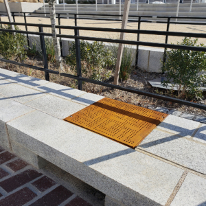 Cast iron solid utility cover with modern Urban Rhythms pattern.