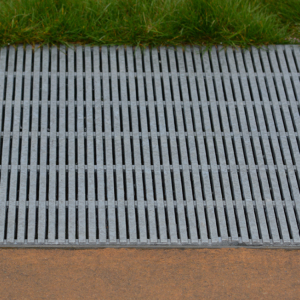 Raw cast aluminum drain grates in linear Regular Joe pattern