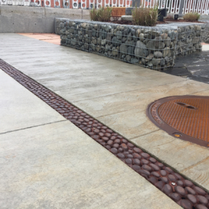 Cast iron trench drain grates in realistic River Rock pattern