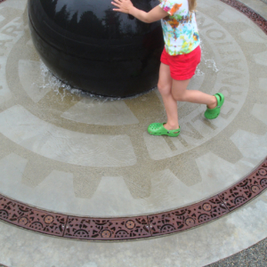 Cast iron radius trench grates in Dynamo pattern around a waterpark fountain