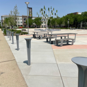 Cast aluminum bollards with grey powder coat finish in Tak Round pattern, resembling large nail