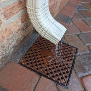 Cast iron drain grate with decorative fleur-de-lis pattern